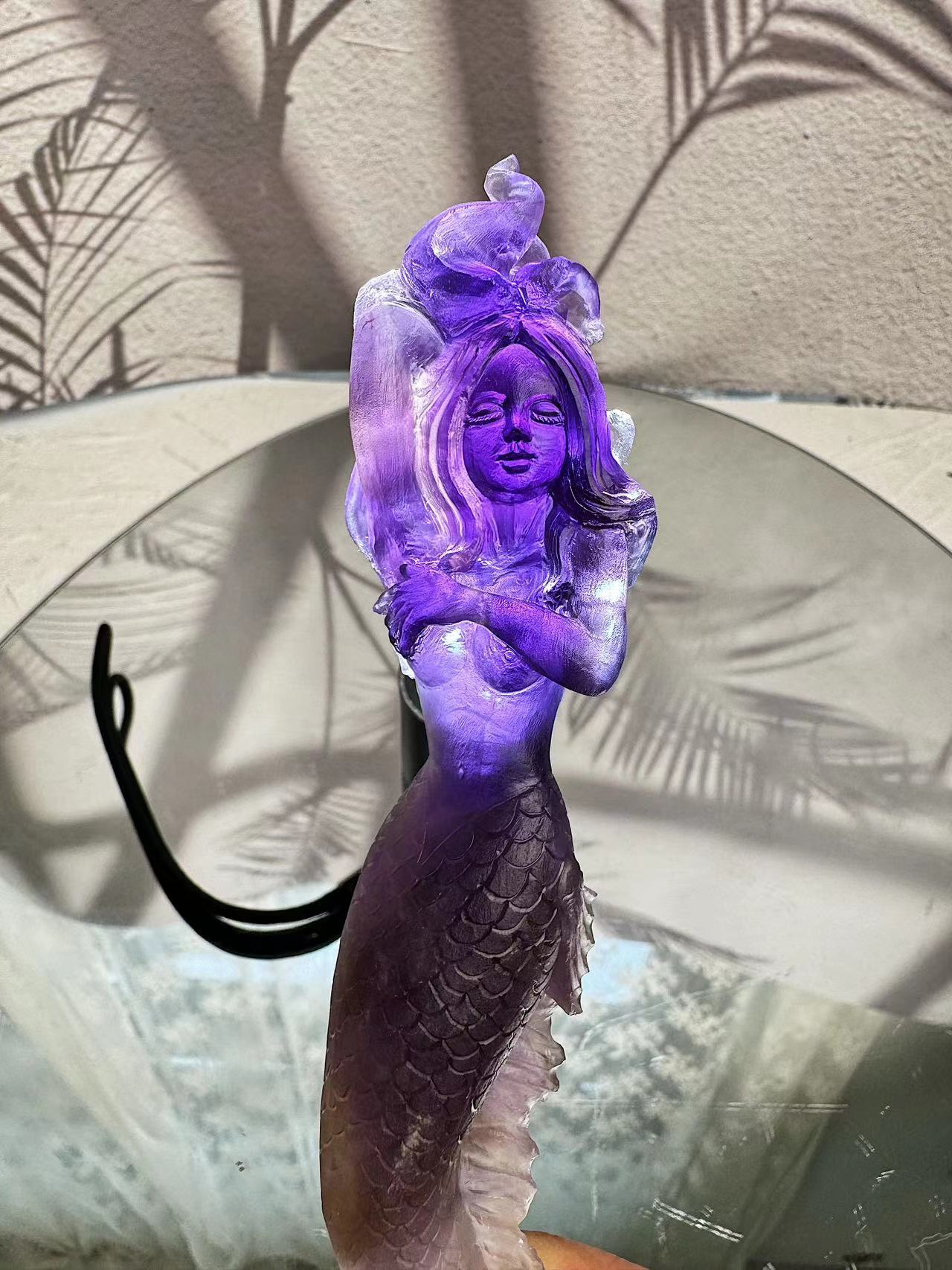 Mermaid carving from purple crystal