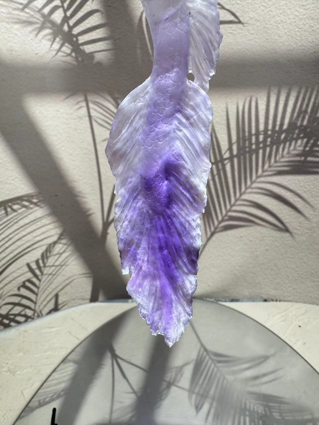 Mermaid carving from purple crystal