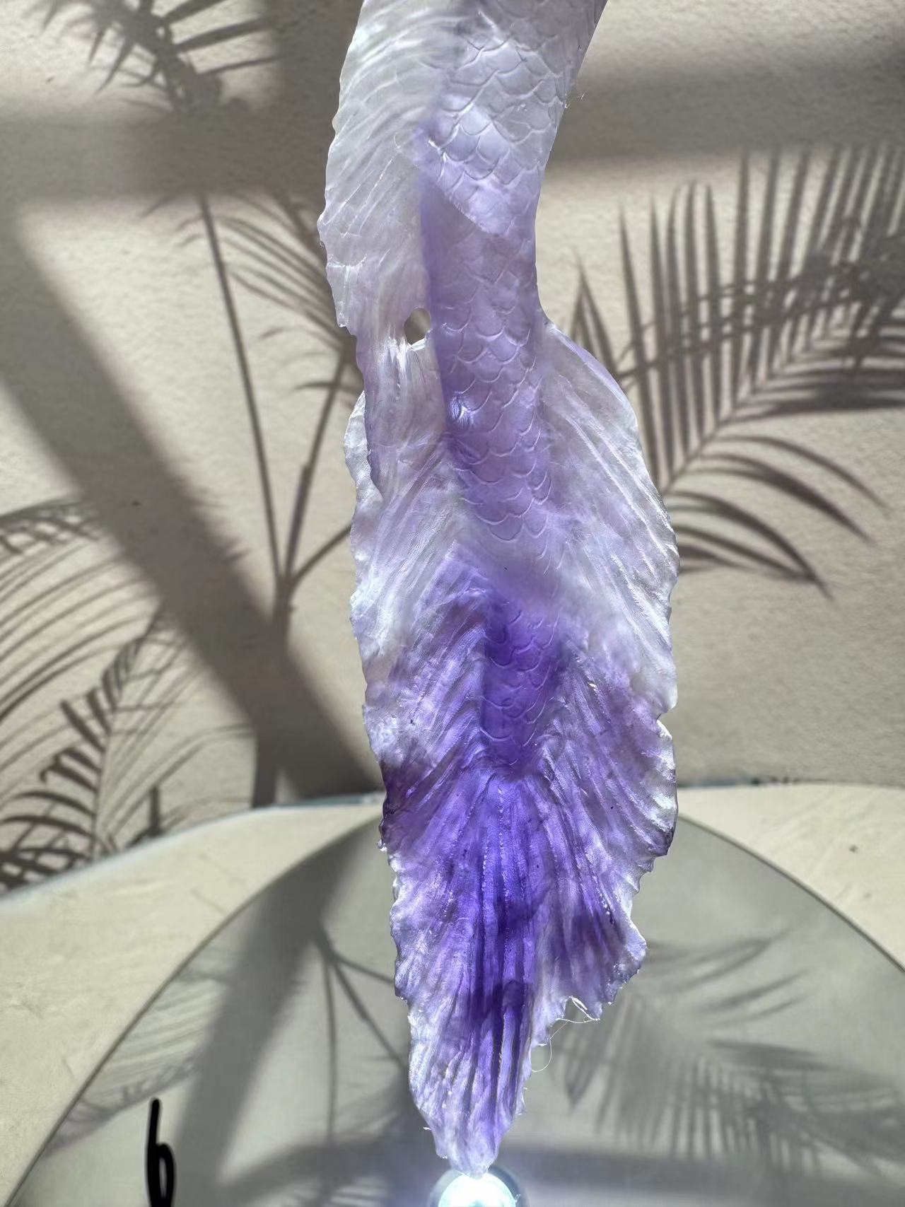 Mermaid carving from purple crystal