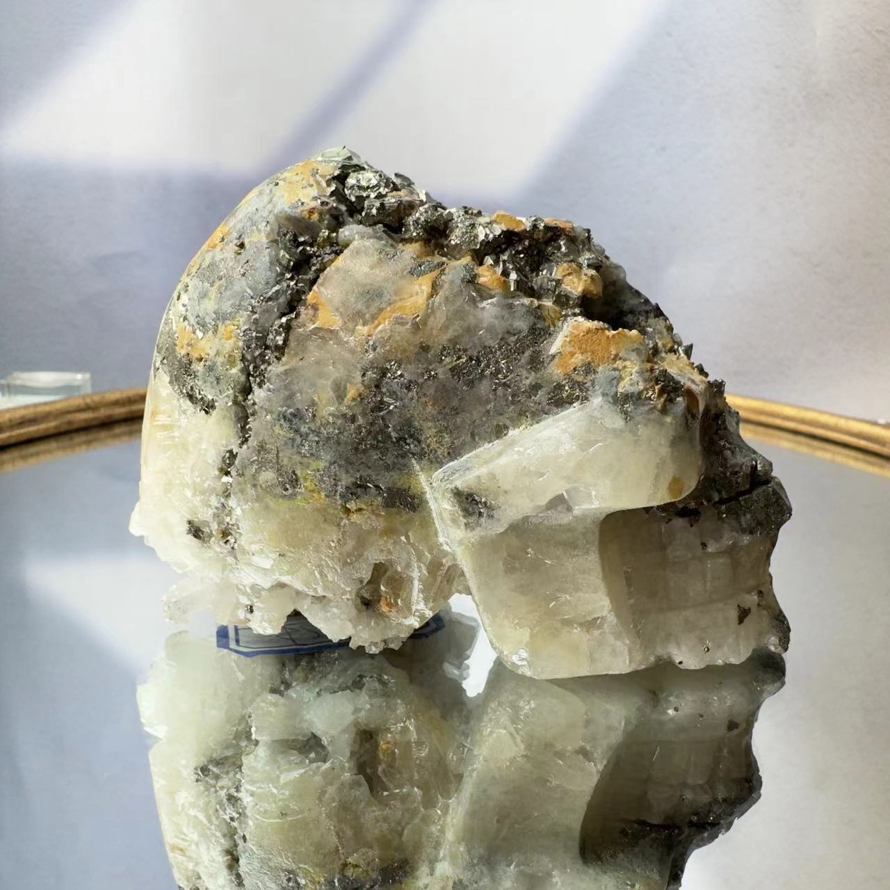 Skull carved from pyrite crystal symbiosis